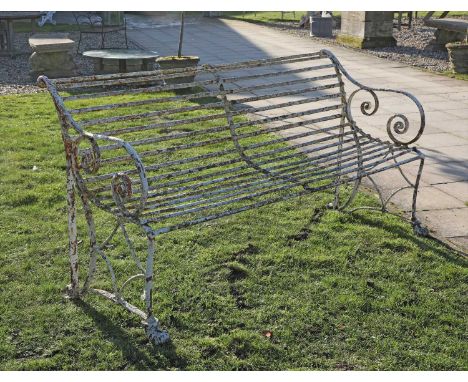 A large French Arras iron garden bench, late 19th century, with scrolling arms and supports, 183cm wide 70cm deep 94cm high