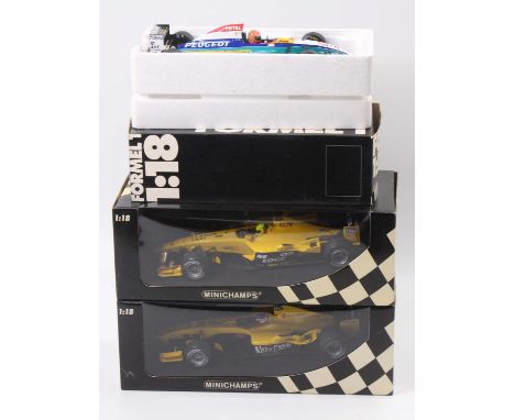 A Minichamps Jordan Peugeot 1/18 scale boxed diecast group to include an Eddie Irvine Jordan Peugeot EJR195 race car, togethe