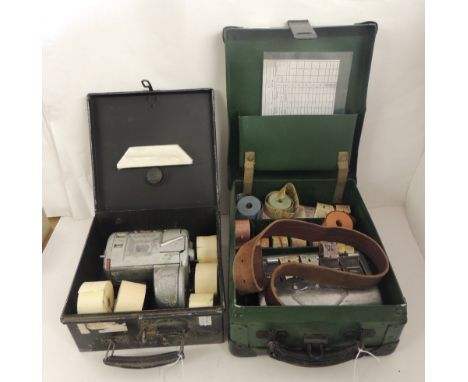 An Almex bus ticket machine with rolls of plain paper in metal box together with a bus ticket machine on original leather str