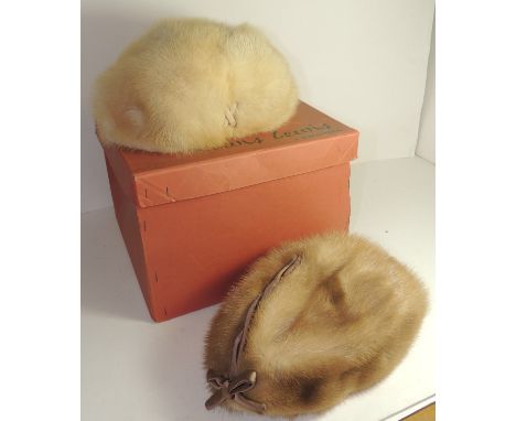 A c.1960's light fur hat by Mitzi Lorenz, London with brown silk bow trim and together with another fur hat by Edna Wallace (