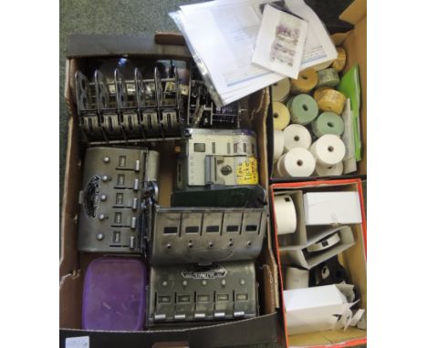 Two bus ticket machines, some parts of ticket machines, labels and reels of paper tickets (a lot)