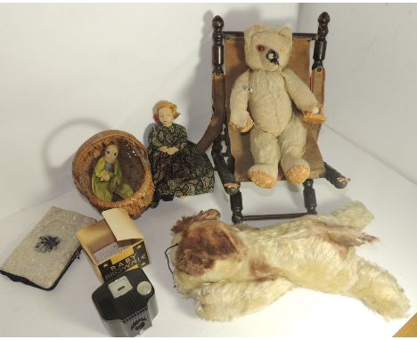 An early 20th Century teddy bear in very worn condition; a small late 19th/early 20th Century folding chair with turned suppo