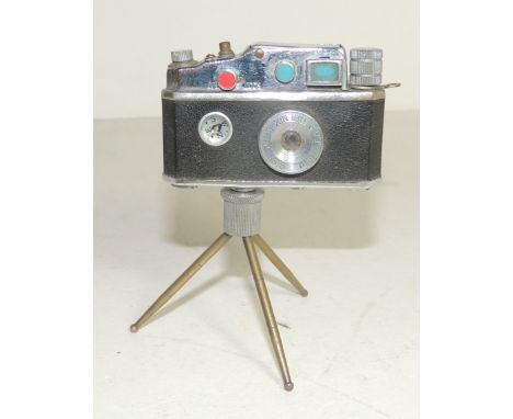 A novelty Phenix cigarette lighter in the form of a camera on a tripod stand 10.5cms high