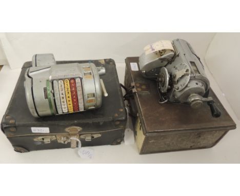 An Almex bus ticket machine in metal case together with another bust ticket machine in metal case (2)