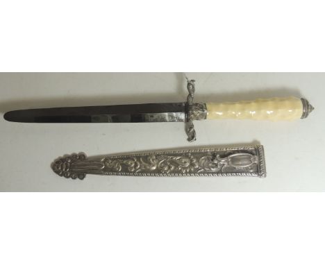 A late 19th Century South American dagger having long ivory grip with bulls head quillons, straight double edged blade and in