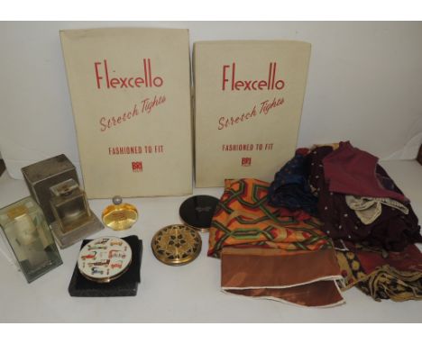 An unopened pack of Bri Nylon Flexcello tights; another unused pair in box; a Stratton powder compact in original box; two ot
