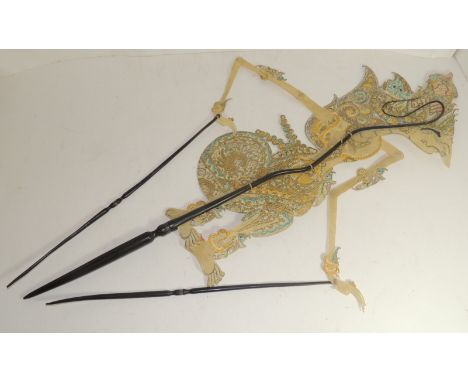 An early 20th Century Indonesian shadow puppet, the decorative figure of pierced leather and on polished wood sticks 74cms lo