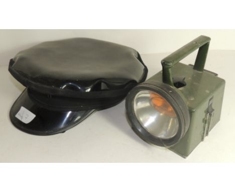 A Bardic hand lamp, green painted and with crows foot mark together with a black peaked cap (2)