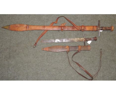 A Sudanese Kaskara in leather scabbard together with a a similar short blade sword in leather scabbard (2) ++both with wear