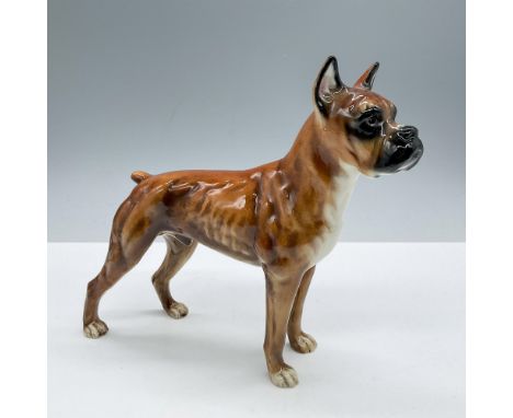 Glazed finish. Depicts a golden brown standing dog. Goebel backstamp. Issued: 1968Dimensions: 7.25''L x 2''W x 6.75''HManufac