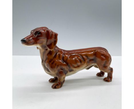 Adorable glazed depiction of a reddish brown standing dog. Goebel backstamp. Marked 1968. Issued: 1968Dimensions: 6''L x 2''W