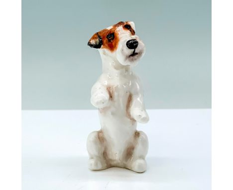 A porcelain Sealyham with white and brown fur that is sitting up on its hind legs. Royal Doulton backstamp. Issued: 1931-1977