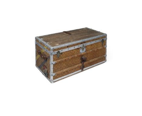 LOUIS VUITTON CANVAS COURIER TRUNKEARLY 20TH CENTURY covered in monogram canvas with aluminium banding, with leather handles,