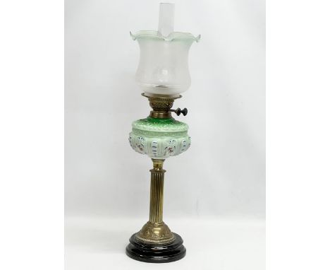 A large Victorian double burner oil lamp with reeded brass column and later shade. 71cm 