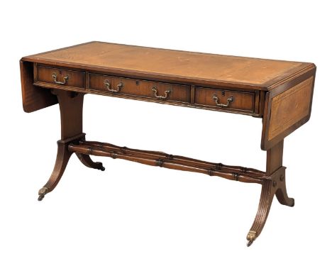 A mahogany writing desk/sofa table with leather top, 3 drawers, 3 dummy drawers and lion paw feet casters, 179.5cm x 64.5cm x