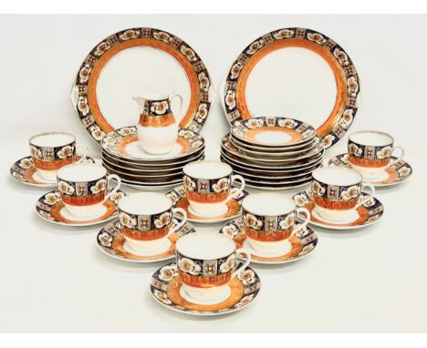 An Early 20th Century 34 piece Beyer &amp; Boch Imari pattern tea service. Circa 1905-1931. 2 cake plates. 12 sandwich plates