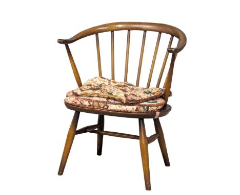 An Ercol Mid Century cowhorn elm and beech armchair. Model 338 