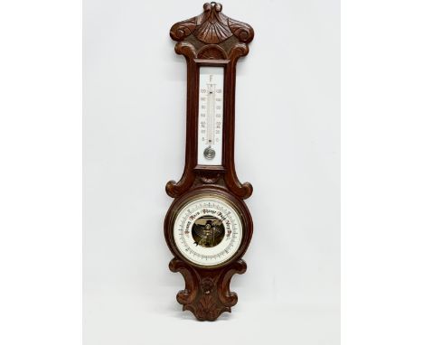 An Early 20th Century oak barometer. Circa 1900. 76cm 