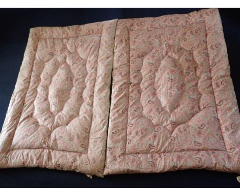 A PAIR OF VINTAGE PINK, GREEN AND BLACK PAISLEY EIDERDOWNS each 110 x 160cm approx (some fading)