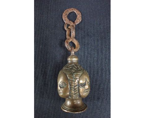 AN ARCHAIC BRONZE FOUR-FACED FINIAL with varying expressions and iron hanging loops 6cm plus loops