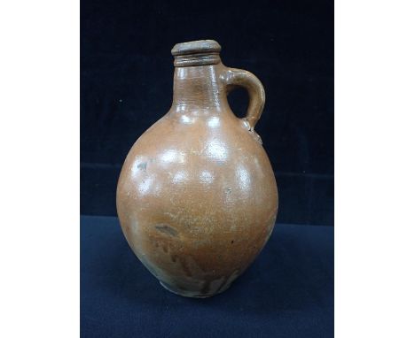AN ENGLISH STONEWARE BELLARMINE TYPE FLASK OR BOTTLE with impressed fleur de lis motifs 25cm high