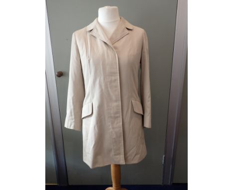 BURBERRY: A LADIES' VINTAGE THREE-QUARTER LENGTH MAC with slanting pockets, concealed buttons, and check lining,  retailed by
