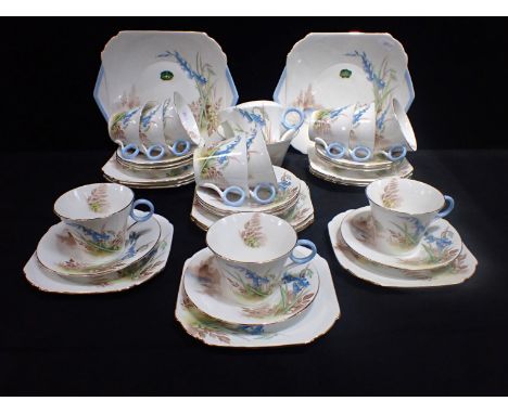 A SHELLEY 'BLUEBELL AND FERN' TEA SERVICE FOR TWELVE with ring handles, the cake plates retaining the original foiled paper l