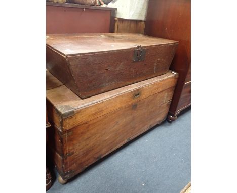 AN OAK TRUNK the hinged lid opening to a vacant interior, with sloped sides, 23cm x 90cm x 45cm; together with a camphor wood