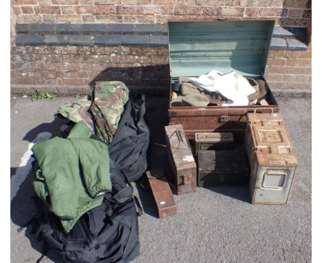 A LARGE TRUNK FILLED WITH MILITARY BED ROLLS, HATS, WEBBING and others