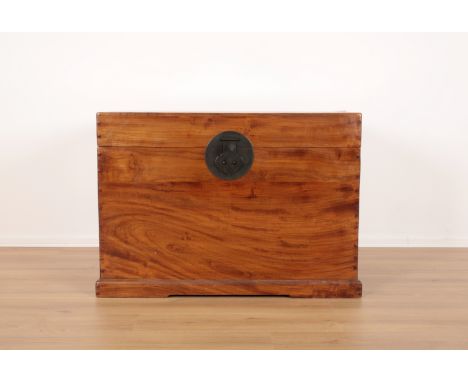 A LARGE CHINESE CAMPHOR WOOD TRUNK 20th century, with metal carrying handles and stylised lock, the interior plain, terminati