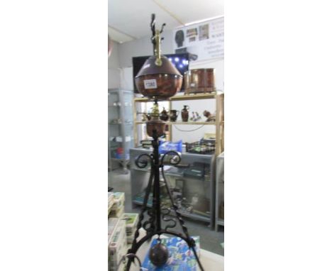 A copper kettle on wrought iron stand by Benham and Froud, designed by Dr. Christopher dresser, circa 1880-1900