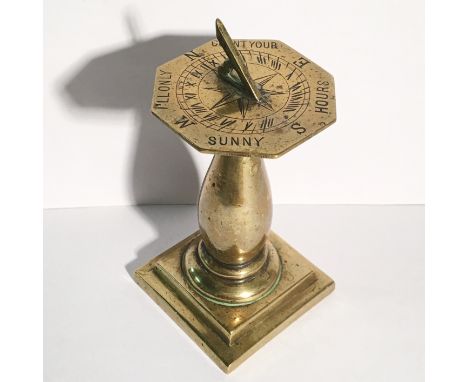 A miniature brass table sundial