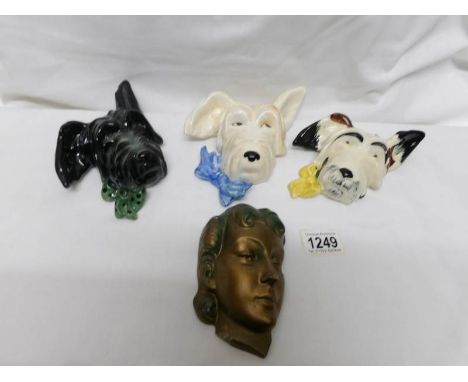 3 ceramic 'dog' wall masks and a plaster deco wall mask
