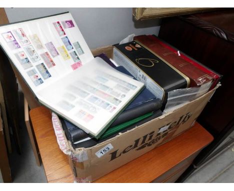 A box of tins and albums of stamps and first day covers