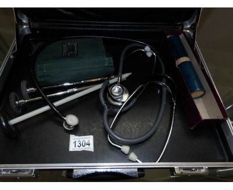 An Accuson dial sphygmomanometer urinometer, A thermometer in steel tube, 3 patella hammers, adult and paediatric stethoscope