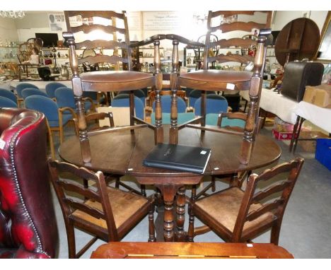 An oak gate leg dining table and a set of 6 dining chairs