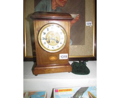A 19th century mahogany mantel clock with shell inlay