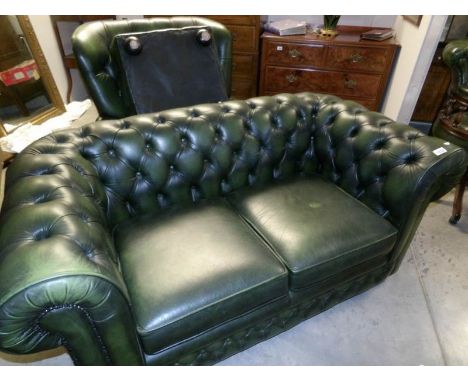 A green leather Chesterfield sofa with matching chair and stool