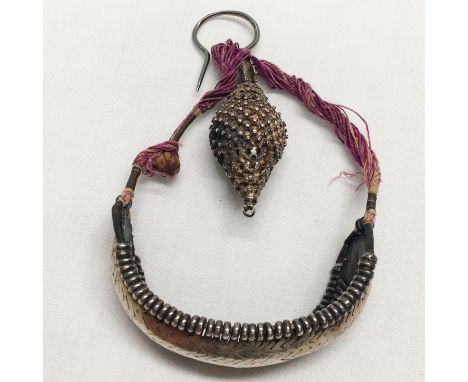 A rare antique silver coloured metal reticulated wrist bangle, possibly Arabian together with a silver coloured metal hook pe