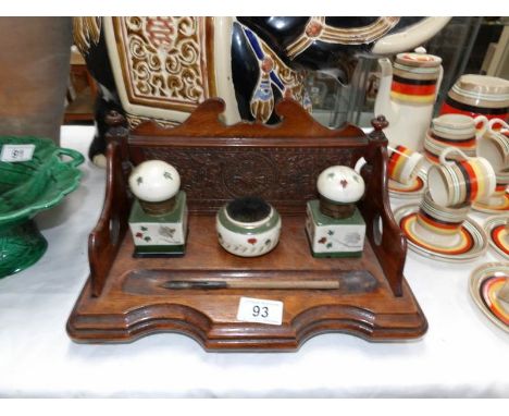 An oak inkstand with ceramic ink well and nib cleaner
