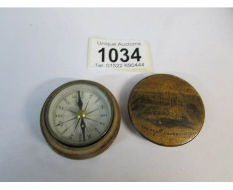 An old compass in wooden case