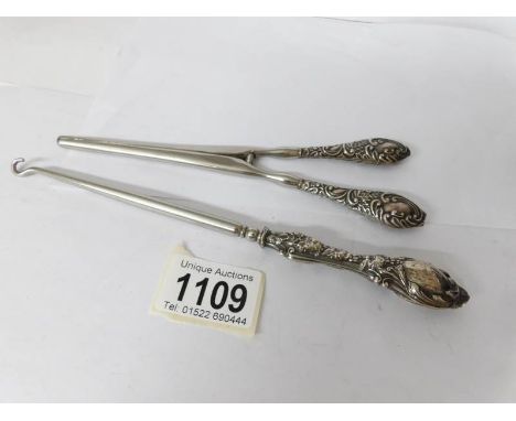 A silver handled  button hook and glove stretchers