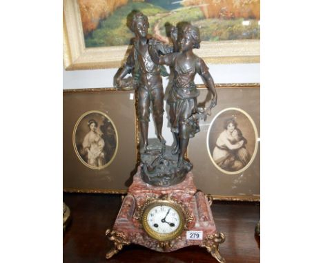A French marble and gilt clock surmounted pair of figures