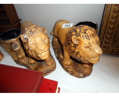 A pair of art deco plaster lion planters
