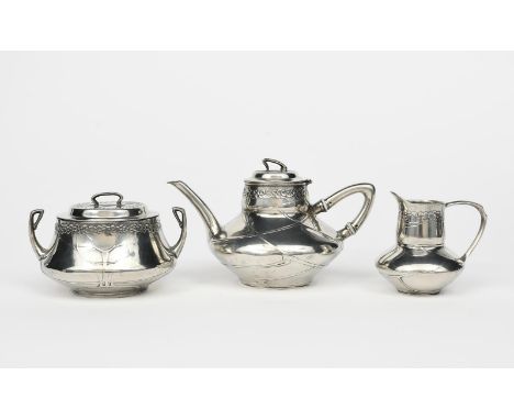 An Art Nouveau Urania pewter three piece tea set designed by Hugo Leven,  model no.1042, cast in low relief with simple folia