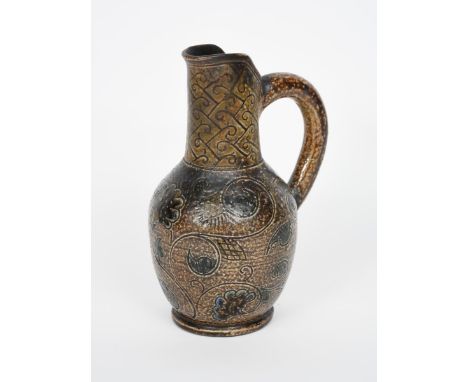 A Martin Brothers stoneware jug by Robert Wallace Martin,  ovoid body with pulled vertical neck and spout, incised with scrol
