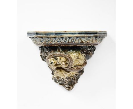 A Martin Brothers stoneware wall bracket designed by Robert Wallace Martin, dated 1878, modelled in relief with a dog-like cr