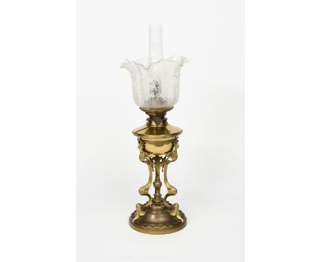 An Art Nouveau brass oil lamp, tripod body on domed base, with flume and frosted glass shade with Glasgow Rose panels, conver