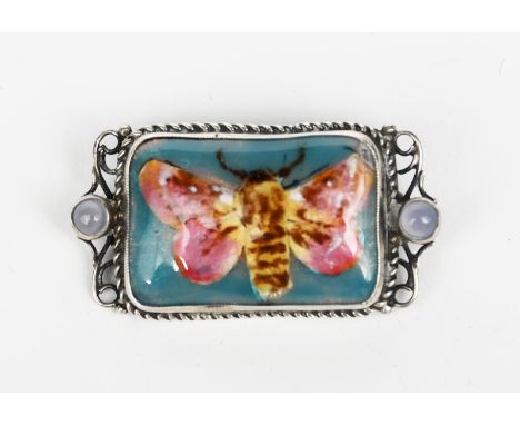 A George Hunt silver and enamel brooch, dated 1924, the rectangular wirework frame with central enamel panel of a moth, the w