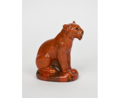 A Pilkington's Royal Lancastrian model of a panther,  modelled seated,  covered in a mottled orange glaze impressed marks, pr